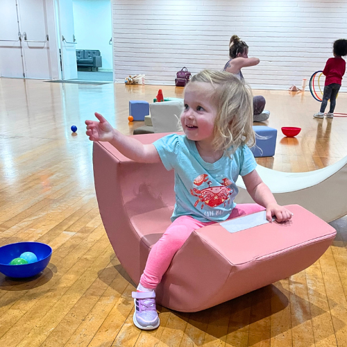 child playing in a movement based sensory play class