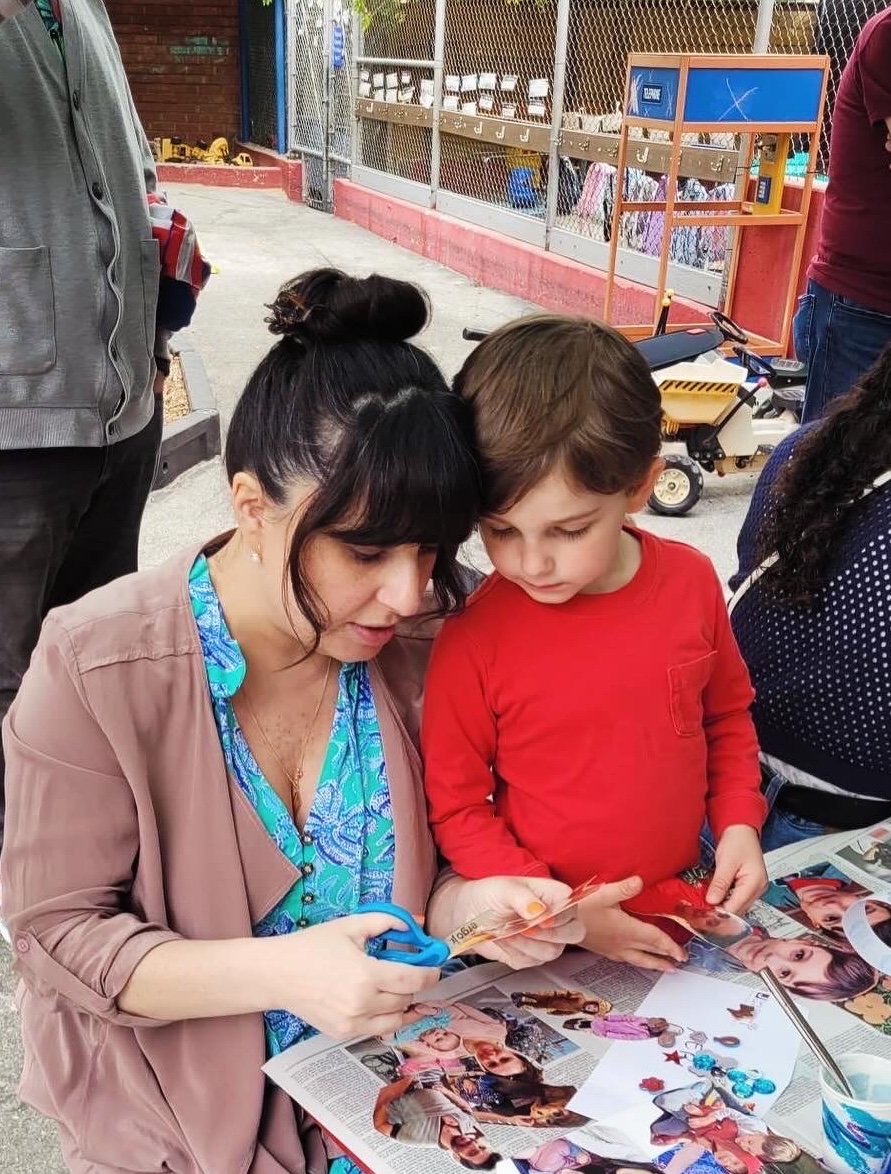 child and his mother working on an arts & crafts project