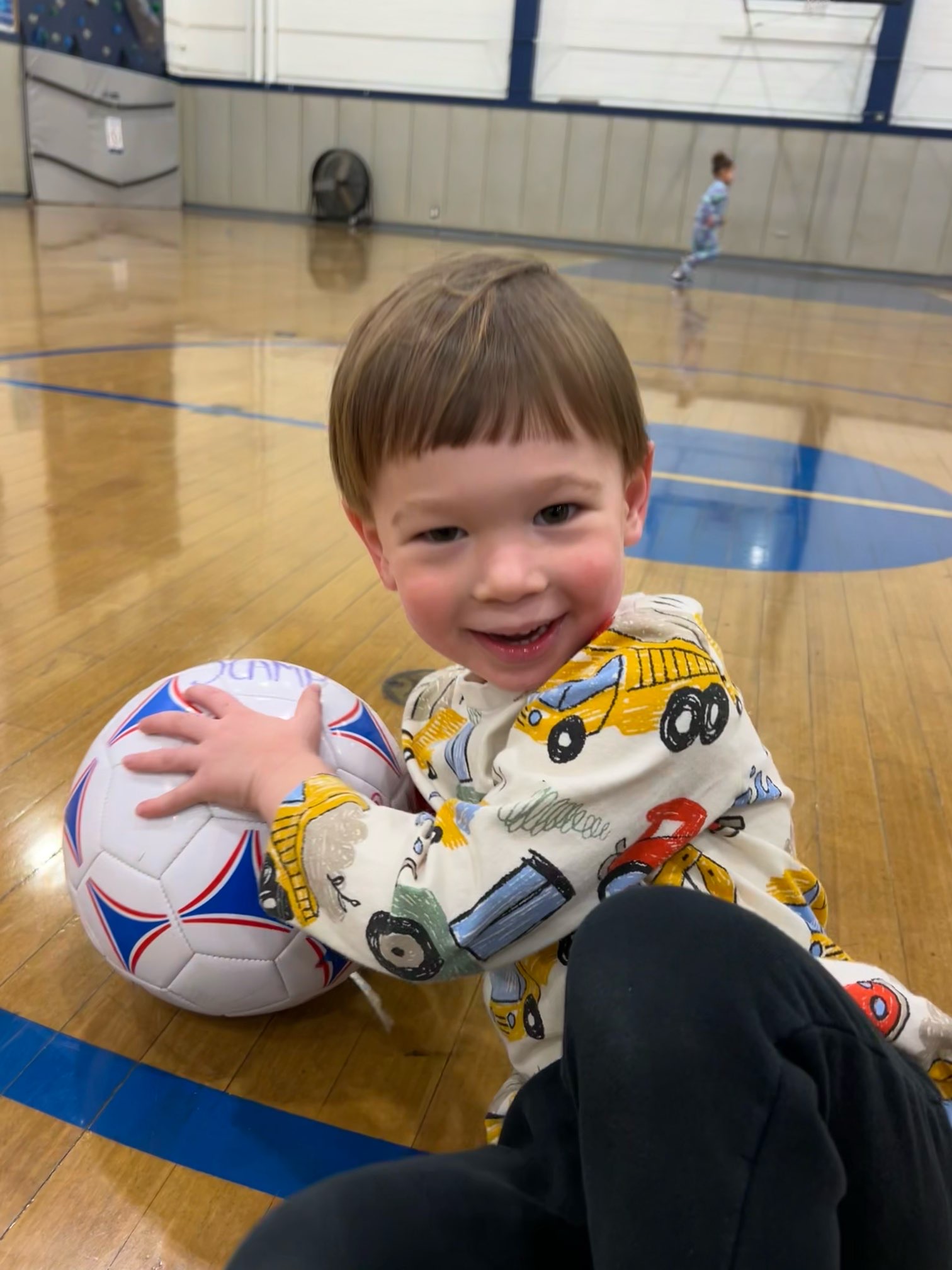 Boy in preschool smiling enjoying sports in school