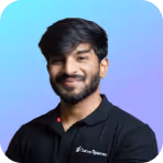 Smiling young man with dark hair and beard wearing a black polo shirt against a blue to purple gradient background.