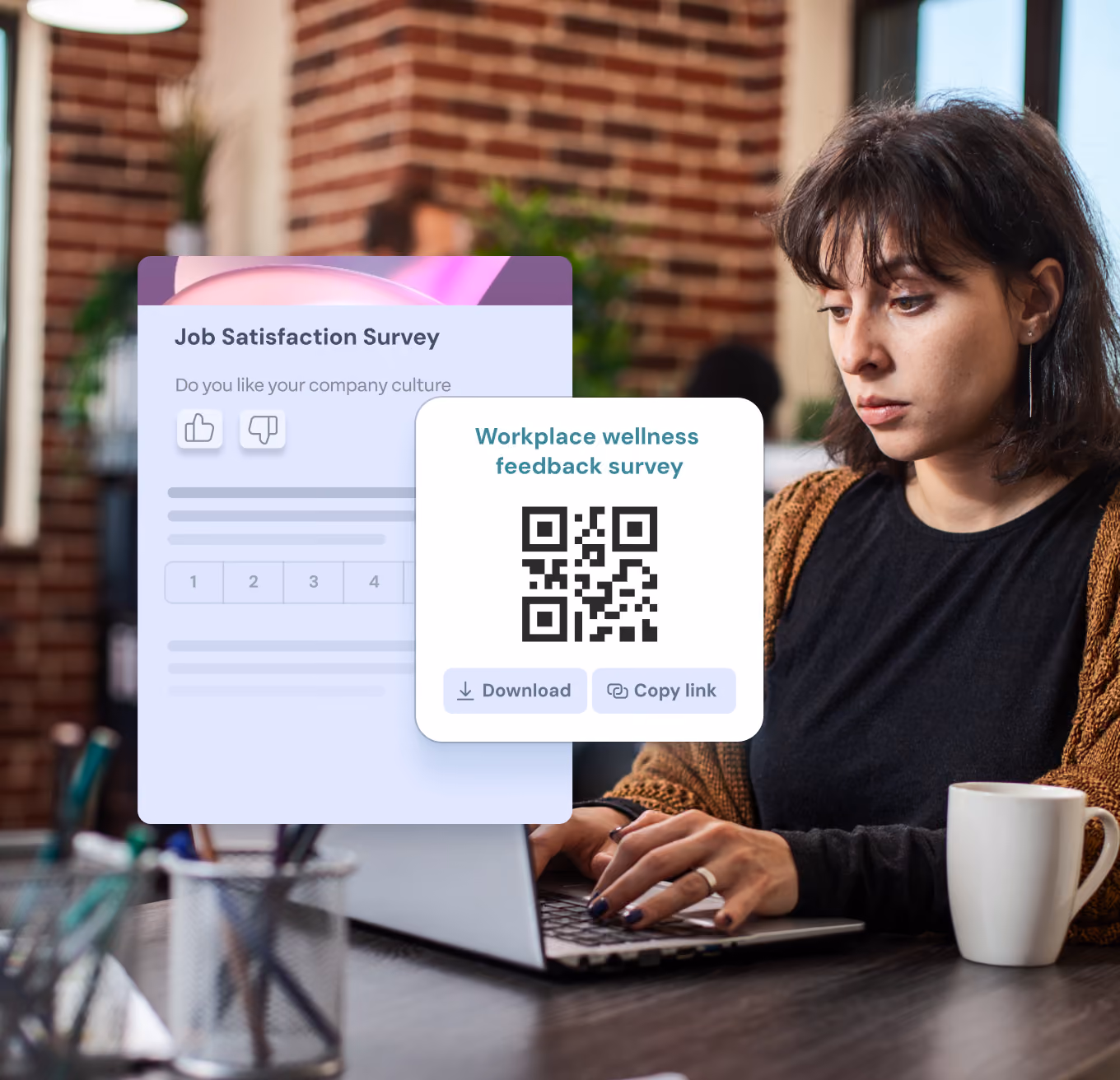 A woman with dark hair sits at a desk working on a laptop in a modern office with brick walls. On the left, overlay graphics show a job satisfaction survey with thumbs up and down icons and a workplace wellness feedback survey QR code with download and copy link options.