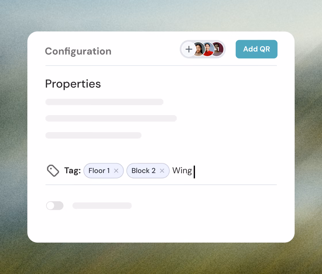 User interface panel titled 'Configuration' showing a section labeled 'Properties' with two tagged items labeled 'Floor 1' and 'Block 2', and a partially typed word 'Wing'. There is an 'Add QR' button and three small circular user avatars with one indicating '+1'.