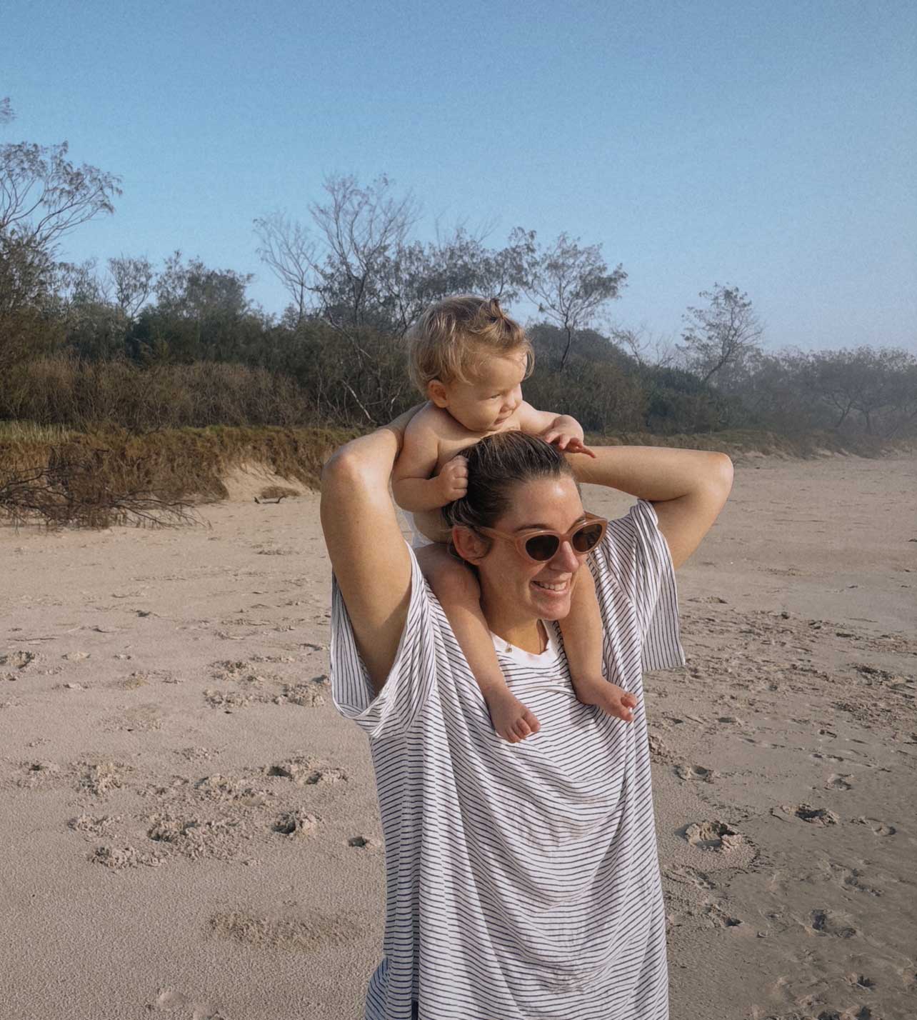 a woman holding a baby on her nape