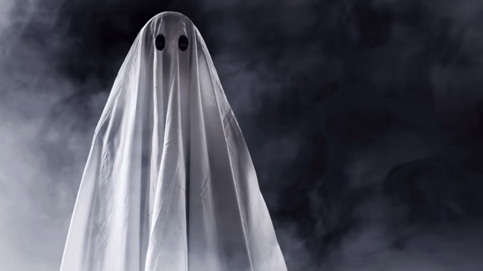 A ghost under a white sheet representing the concept of ghostwriting.