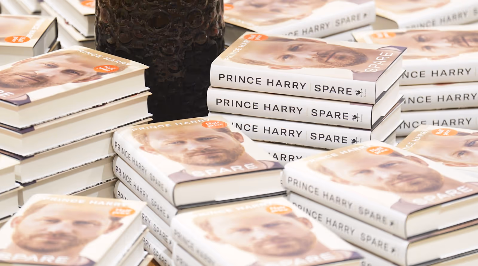 Stacks of Prince Harry’s memoir Spare arranged on a display table.