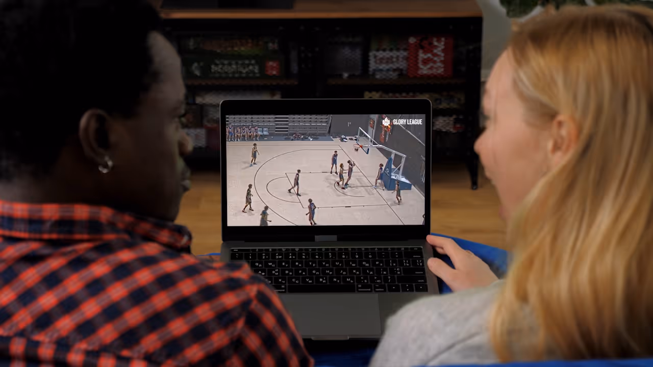 Family engaged with Glory League game video on laptop