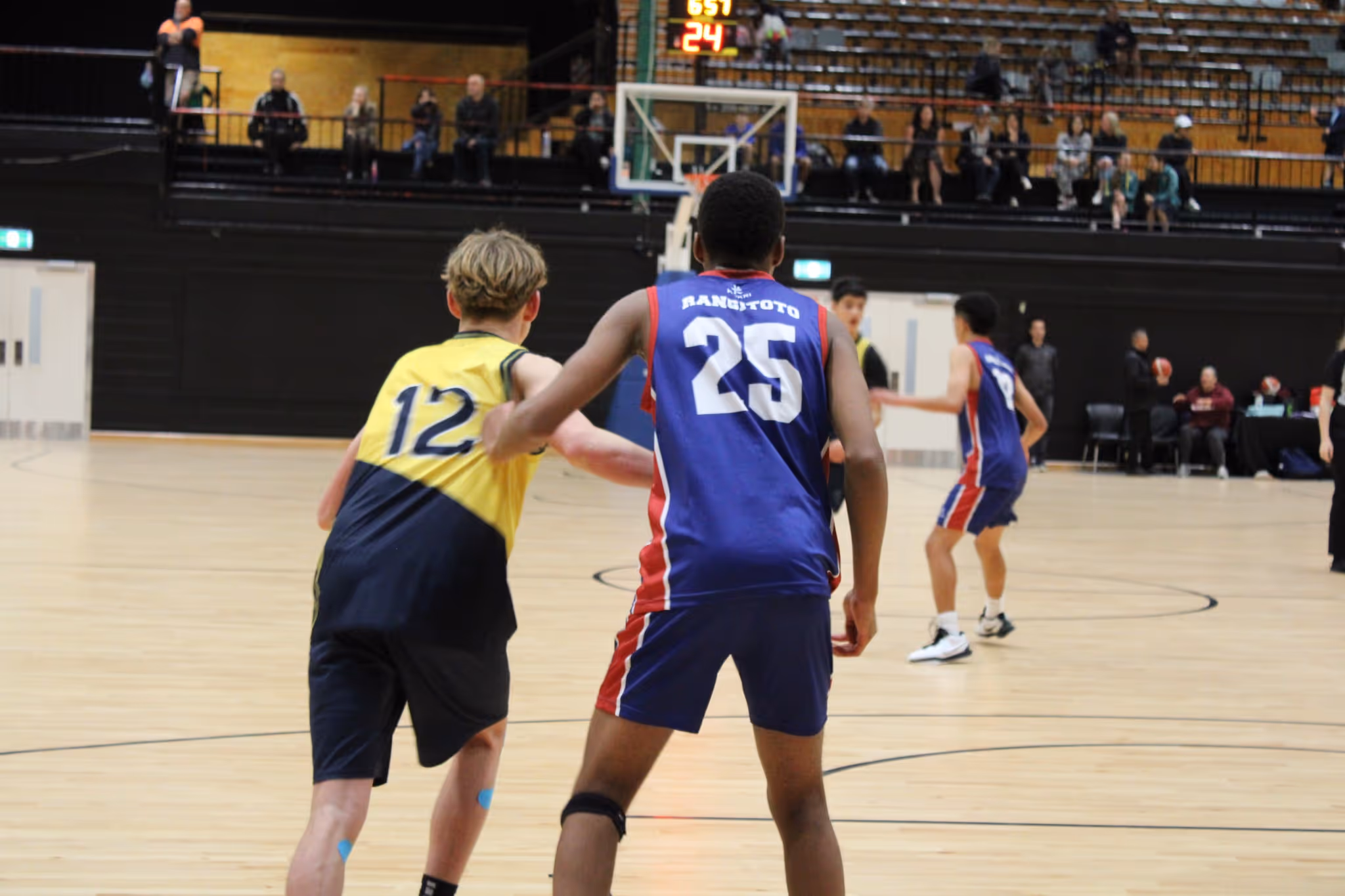 Two basketball players in action, illustrating the impact of Glory League technology on safer gameplay