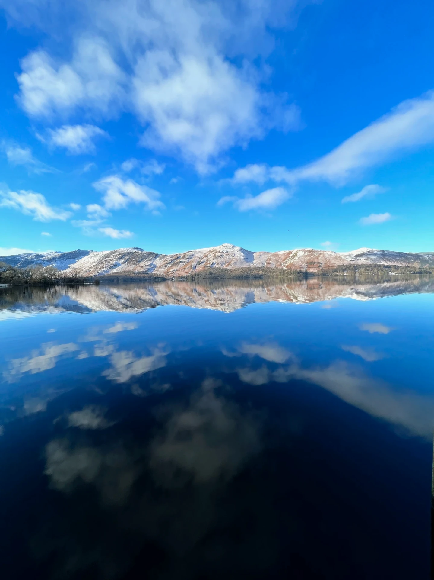 Picturesque view of the Northern lakes in the lake district with the impressive hills in the distance