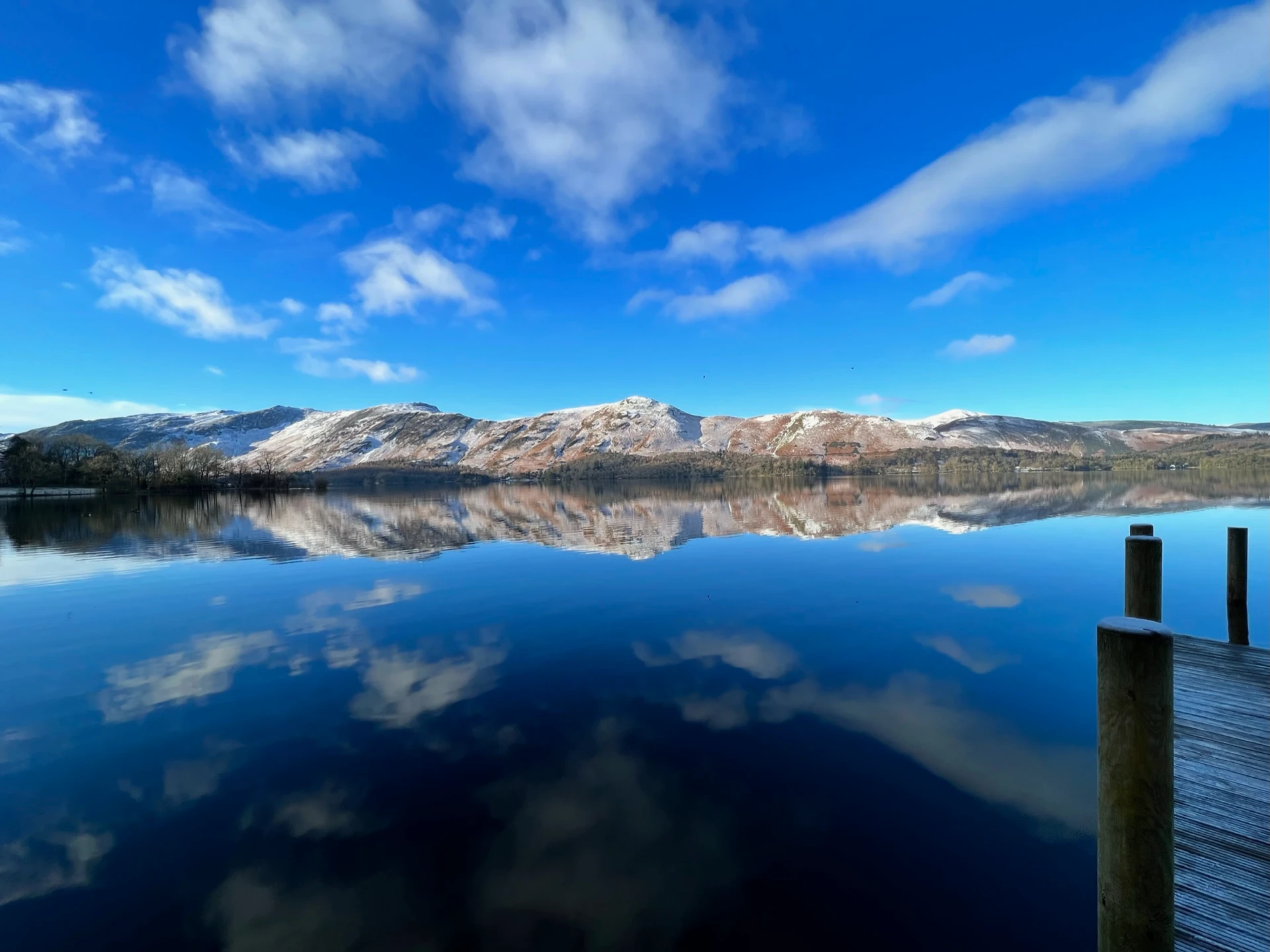 Picturesque view of the Northern lakes in the lake district with the impressive hills in the distance