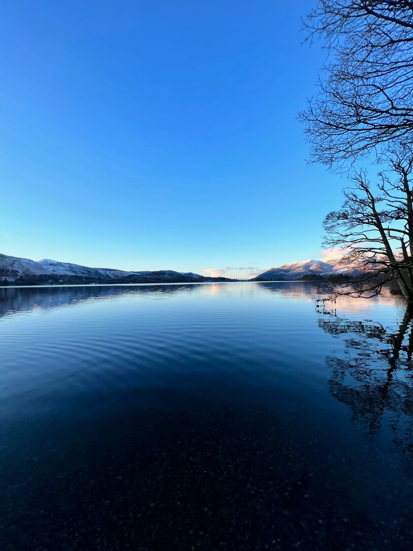 Picturesque view of the Northern lakes in the lake district with the impressive hills in the distance