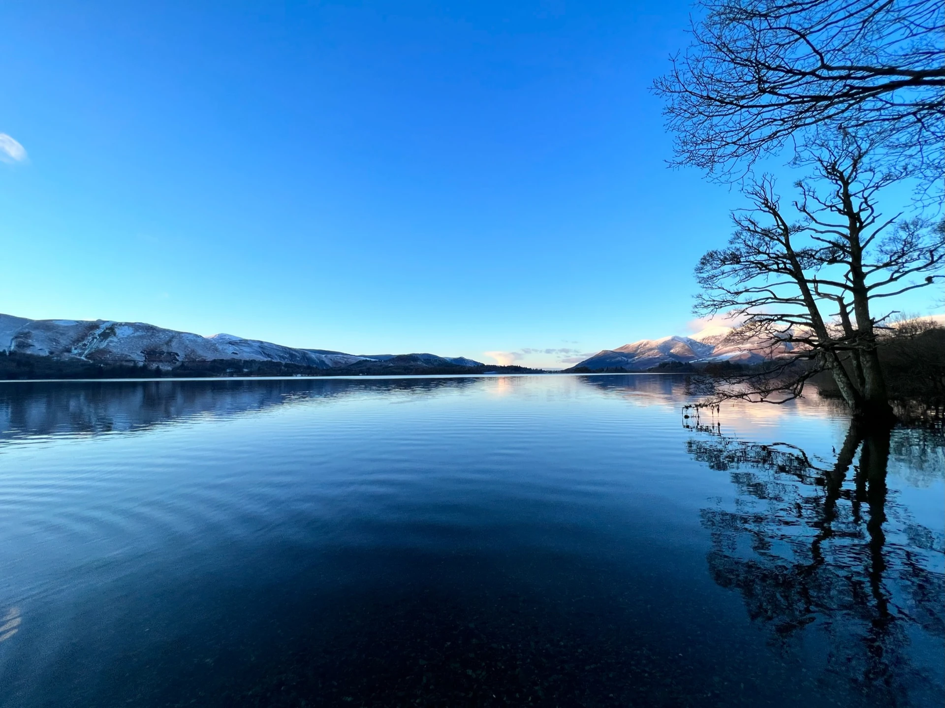 Picturesque view of the Northern lakes in the lake district with the impressive hills in the distance