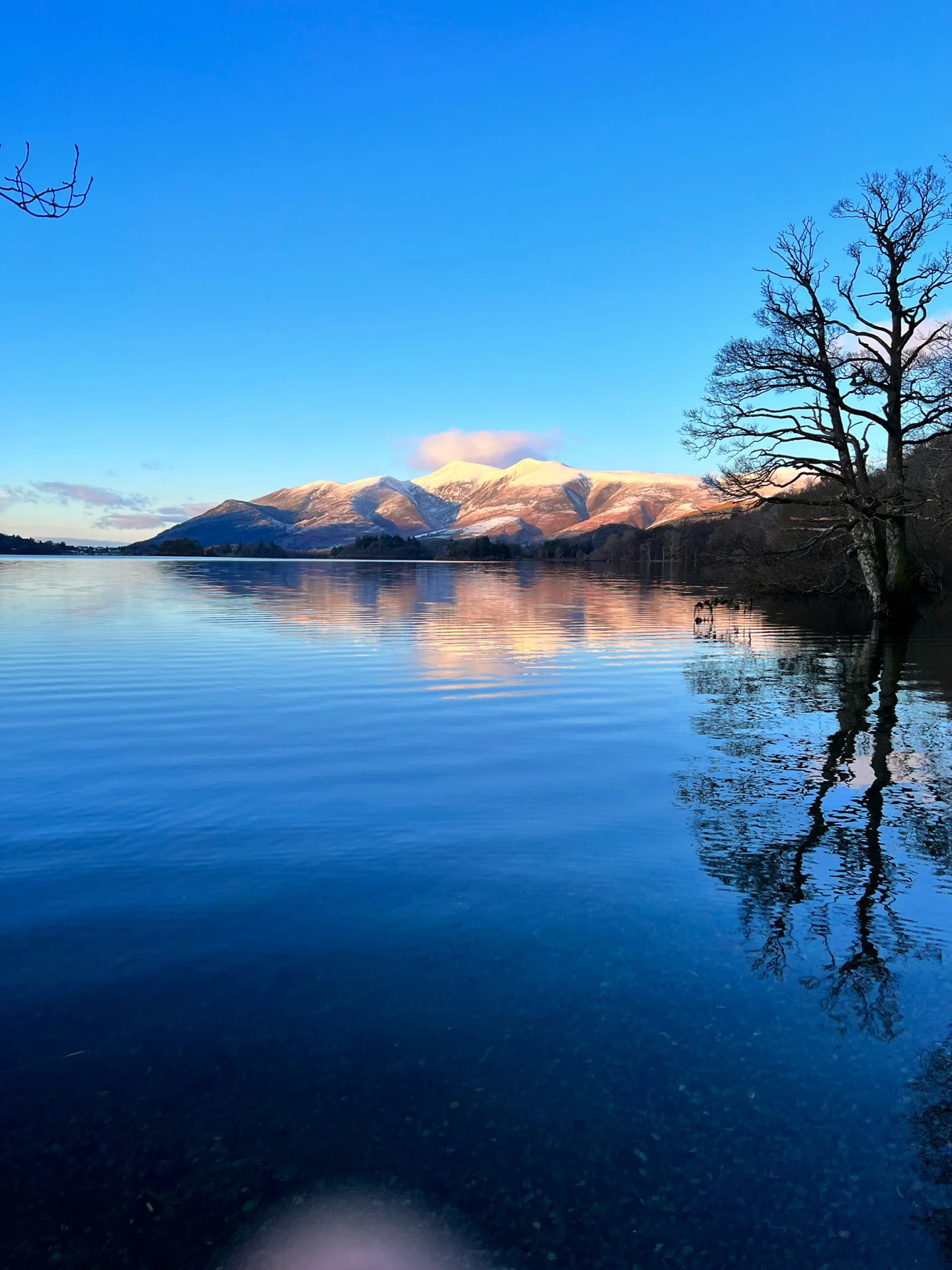 Picturesque view of the Northern lakes in the lake district with the impressive hills in the distance