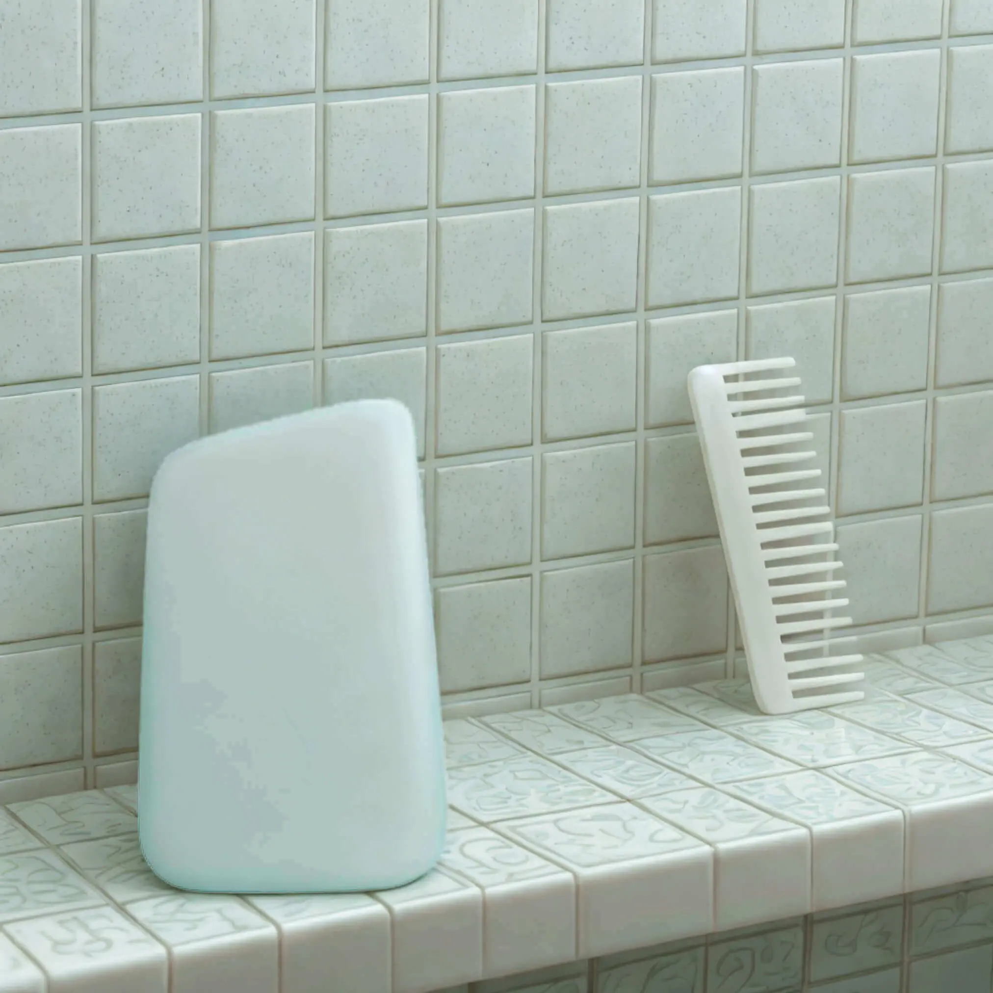 Minimalist bathroom products—a white comb and soap/shampoo bar—against pale mint green tile. The monochromatic styling emphasizes the clean, simple design of these personal care essentials.