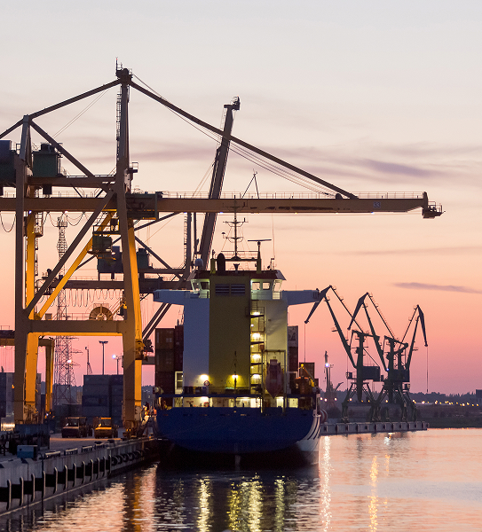 Klaipėda Port, Lithuania at sunset with cargo ship at berth and industrial cranes (Baltic sea freight terminal)