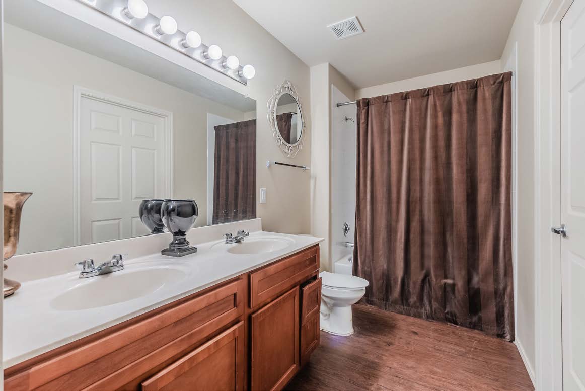 Bathroom with vanity and shower tub combo