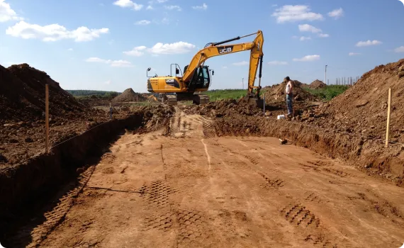 a bulldozer on top of a dirt field