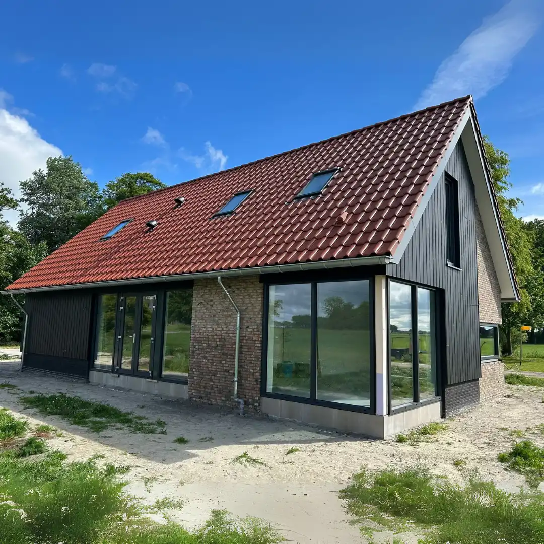 Zijaanzicht van vrijstaande woning met oranje pannen