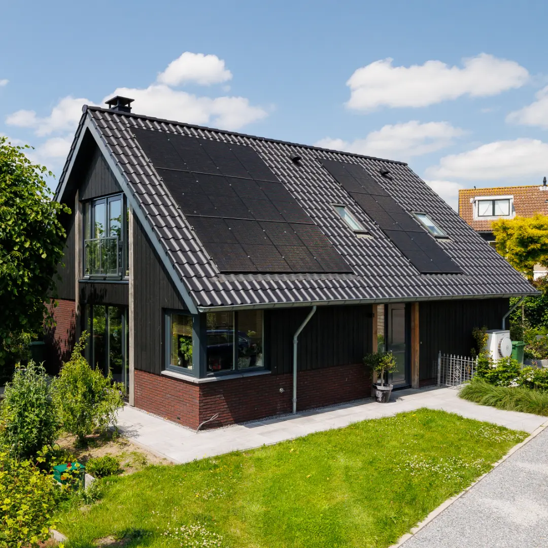 Vooraanzicht van een zwarte schuurwoning met metselwerk