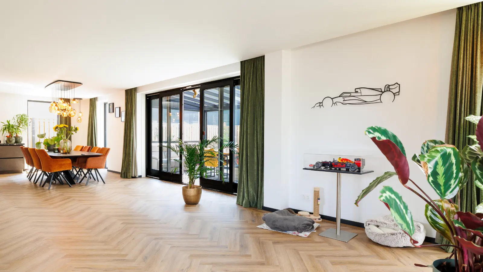 Leefruimte met grote eettafel en oranje stoelen