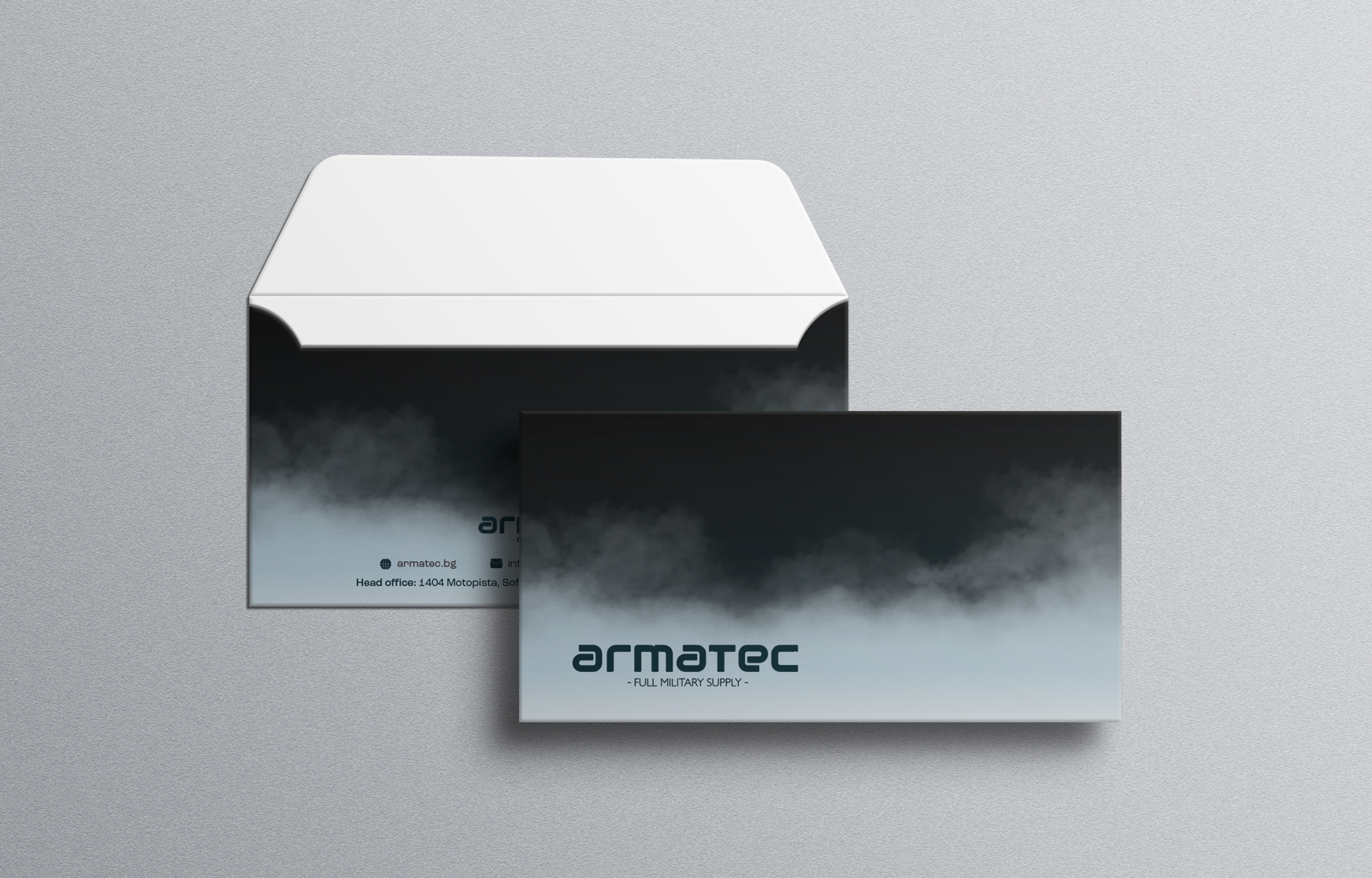 Armatec branded envelope and card mockup with the logo set against a dark smoke gradient