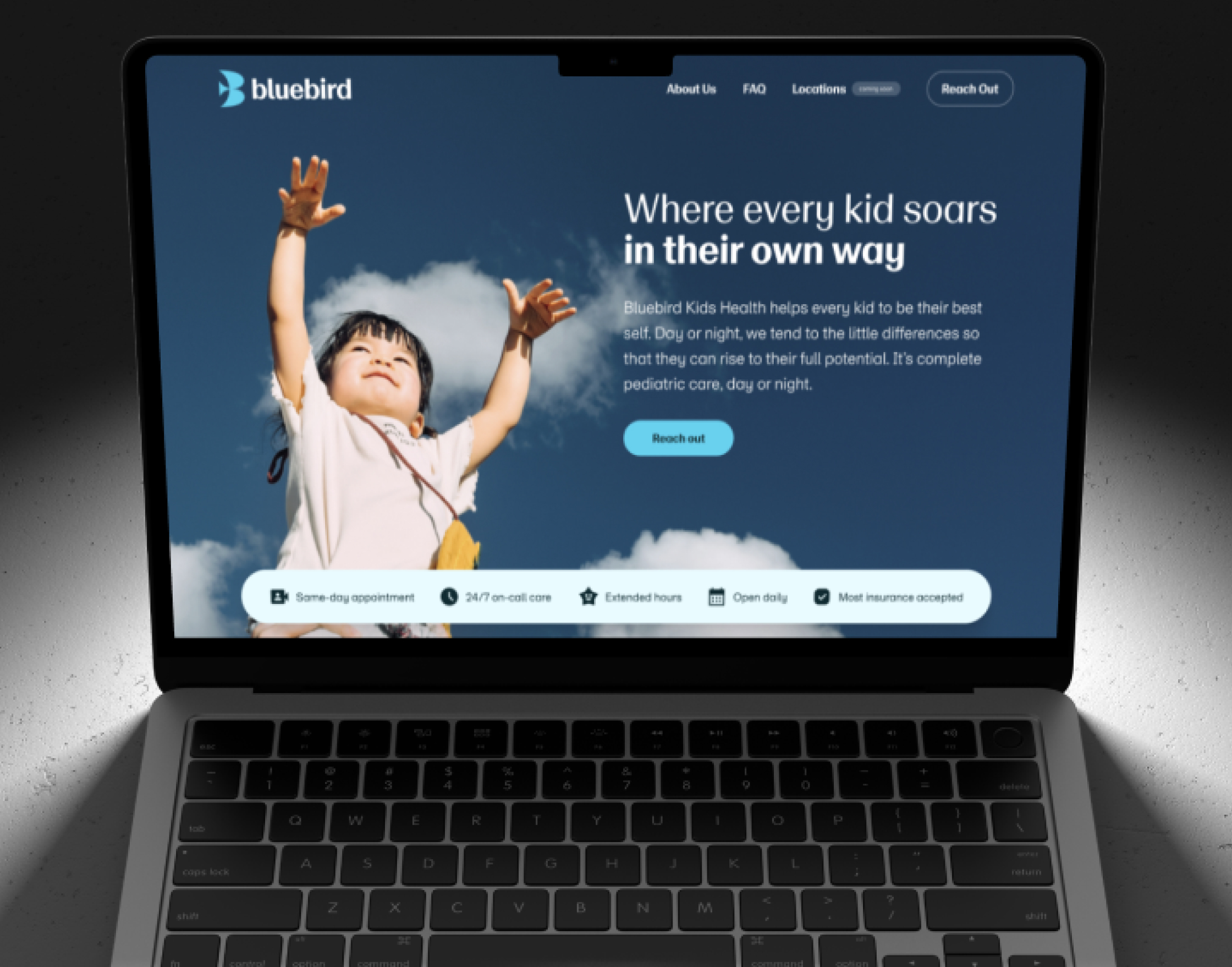 BlueBird Kids Health homepage on a laptop screen against a dark background, hero photo of a child reaching skyward