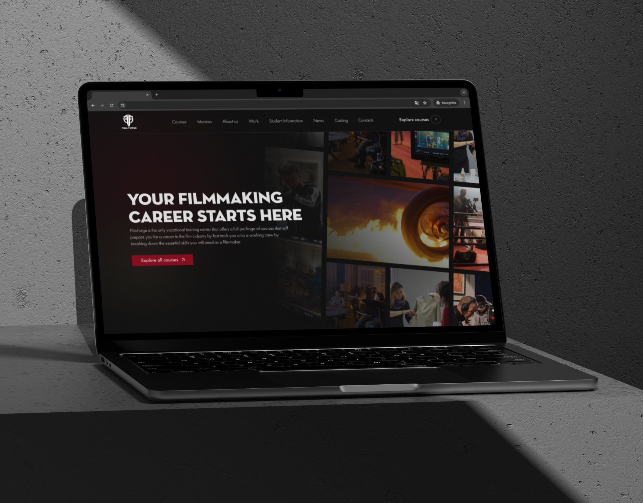 FilmForge homepage on a laptop screen lit by hard shadow on a grey concrete surface in a dark room