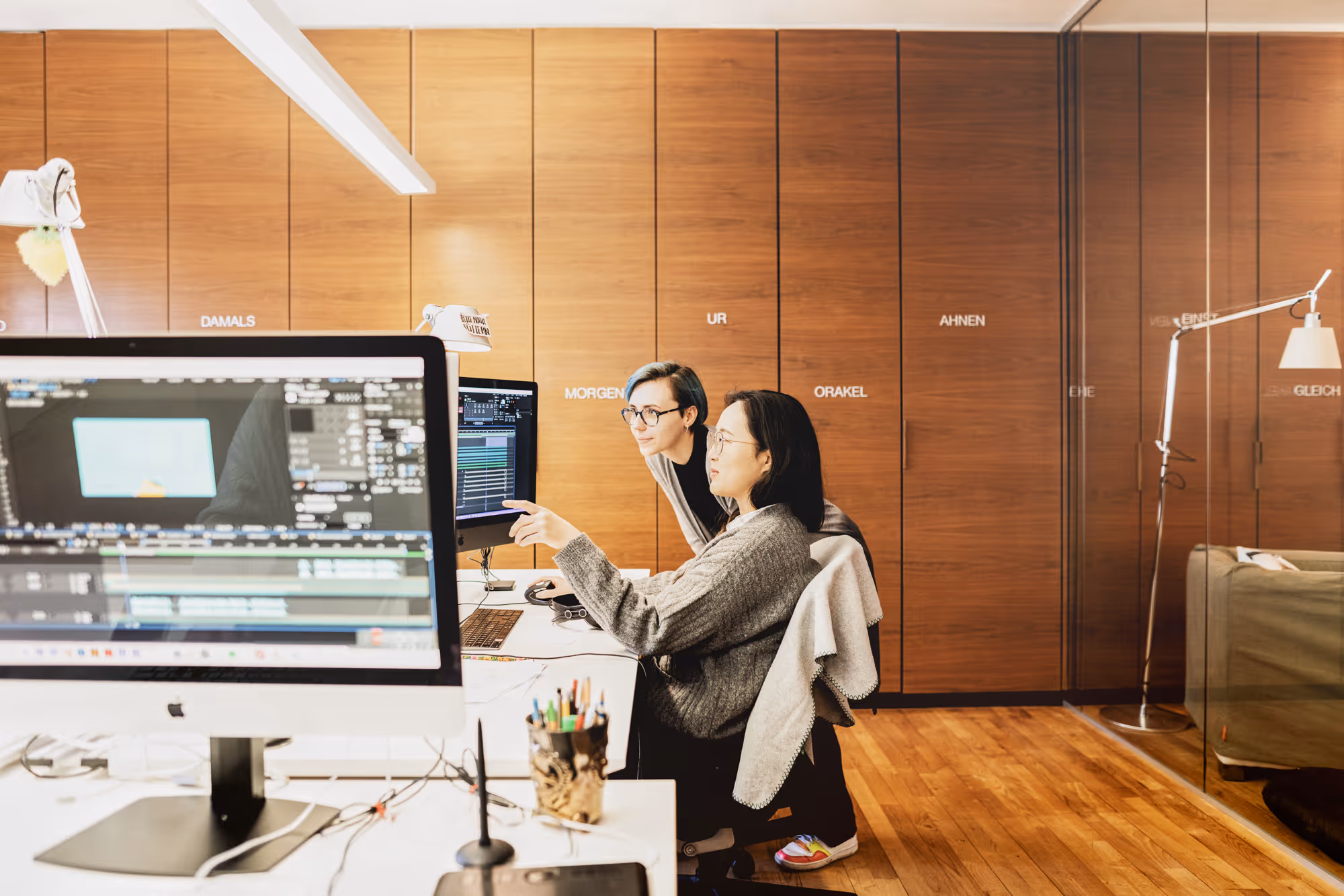 View of the nutcracker office. Two members of the team discuss a project on the screen.