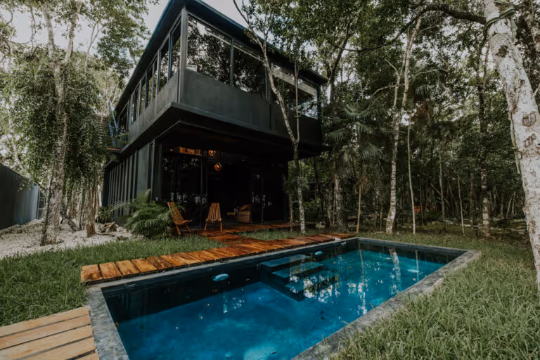 A house with a pool in the middle of the yard.