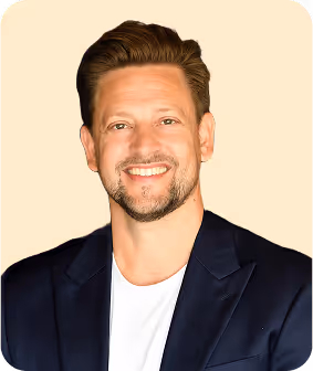 A man in a suit smiling at the camera.