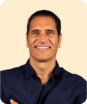 A smiling man with his arms crossed.