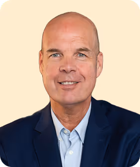 A man in a suit and tie smiling.