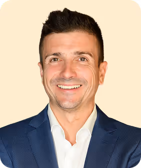 A man in a suit smiling for the camera.