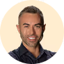 A man in a black shirt is smiling.