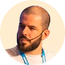 A man with a beard wearing a blue lanyard.