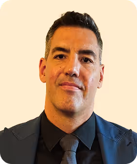 A man in a suit and tie looking at the camera.