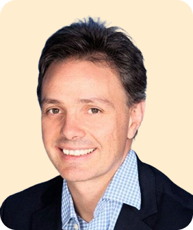 A man in a suit smiling for a picture.