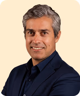 A man with grey hair and a blue shirt.