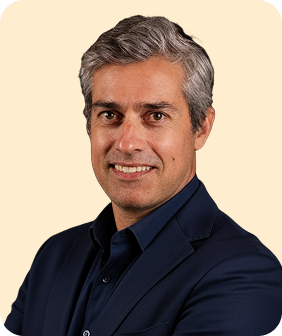 A man with grey hair and a blue shirt.