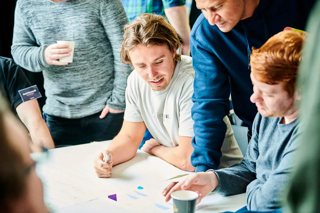 Team members engaged in creative discussions and collaboration.