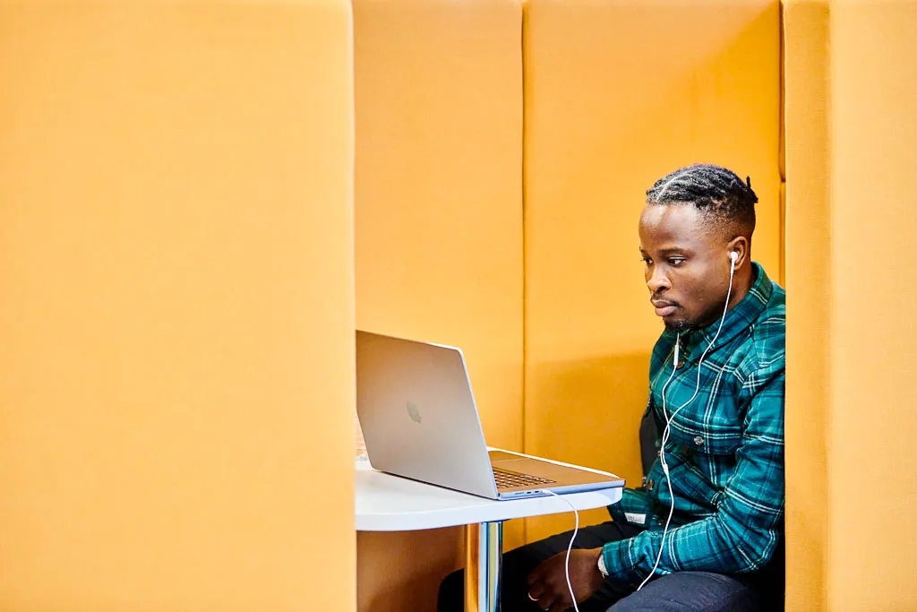 Colleague focusing intently in a quiet workstation.