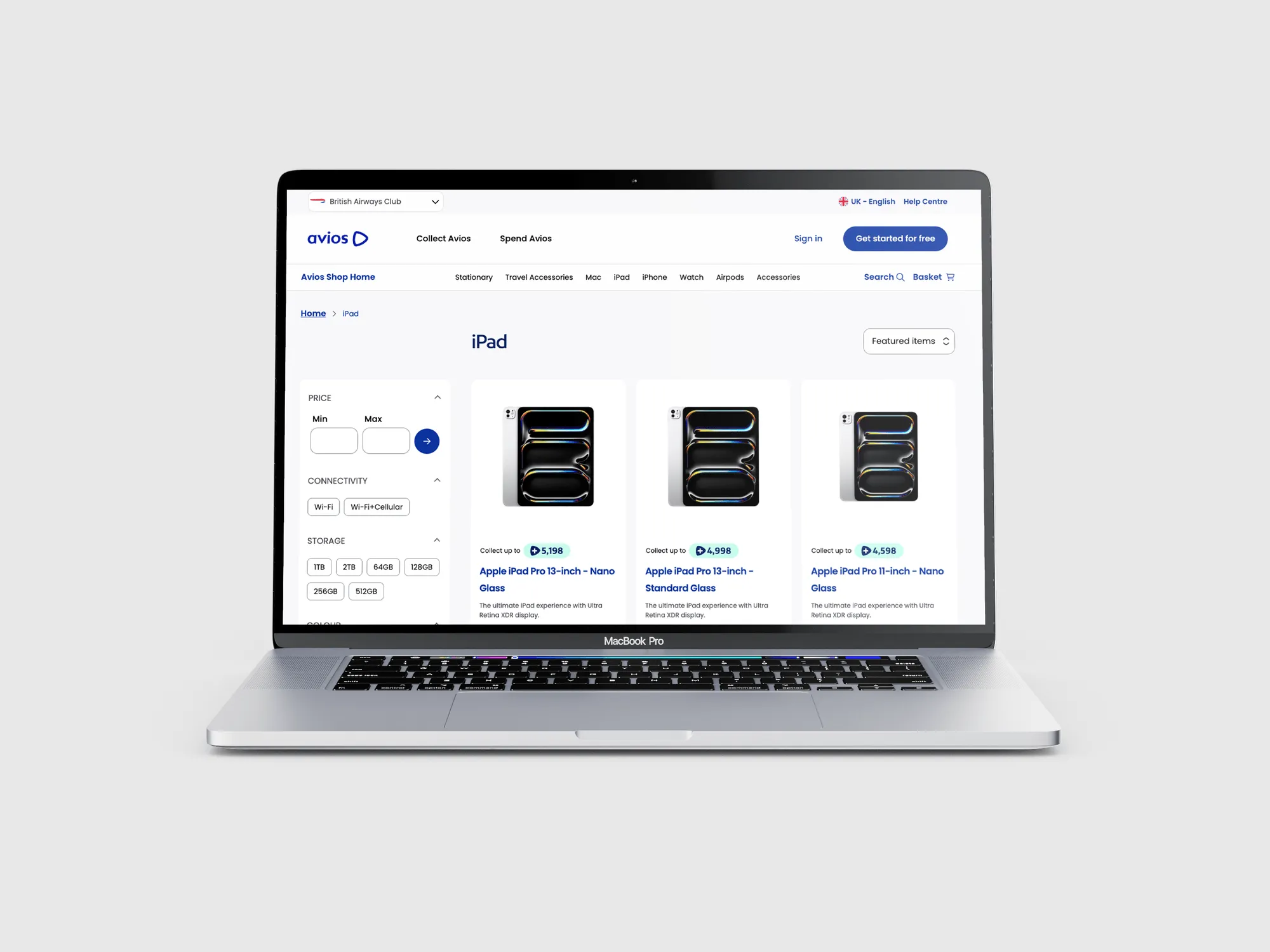 Smiling man wearing a black AWS t-shirt waving with his right hand on stage with bright red lights in the background.