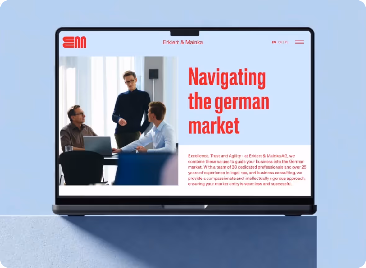 Laptop zeigt eine Webseite von Erkiert & Mainka mit dem Titel ‚Navigating the german market‘ und einem Bild von drei Personen im Gespräch.