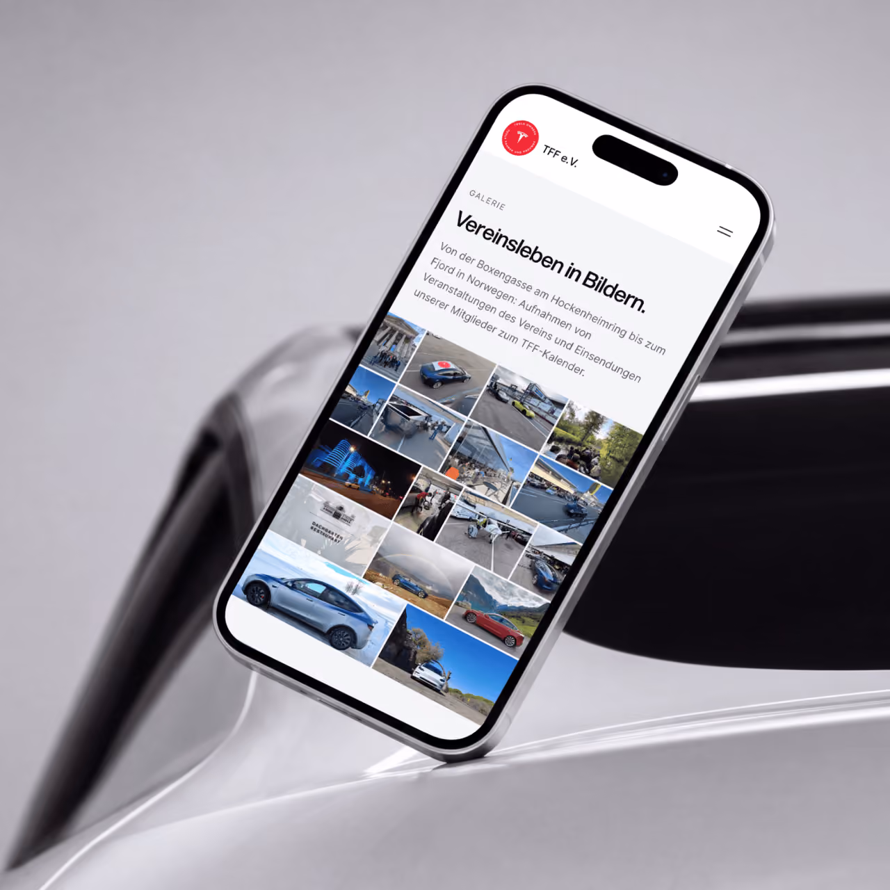 Smartphone on a Tesla showing the “Club life in pictures” gallery of the TFF website.