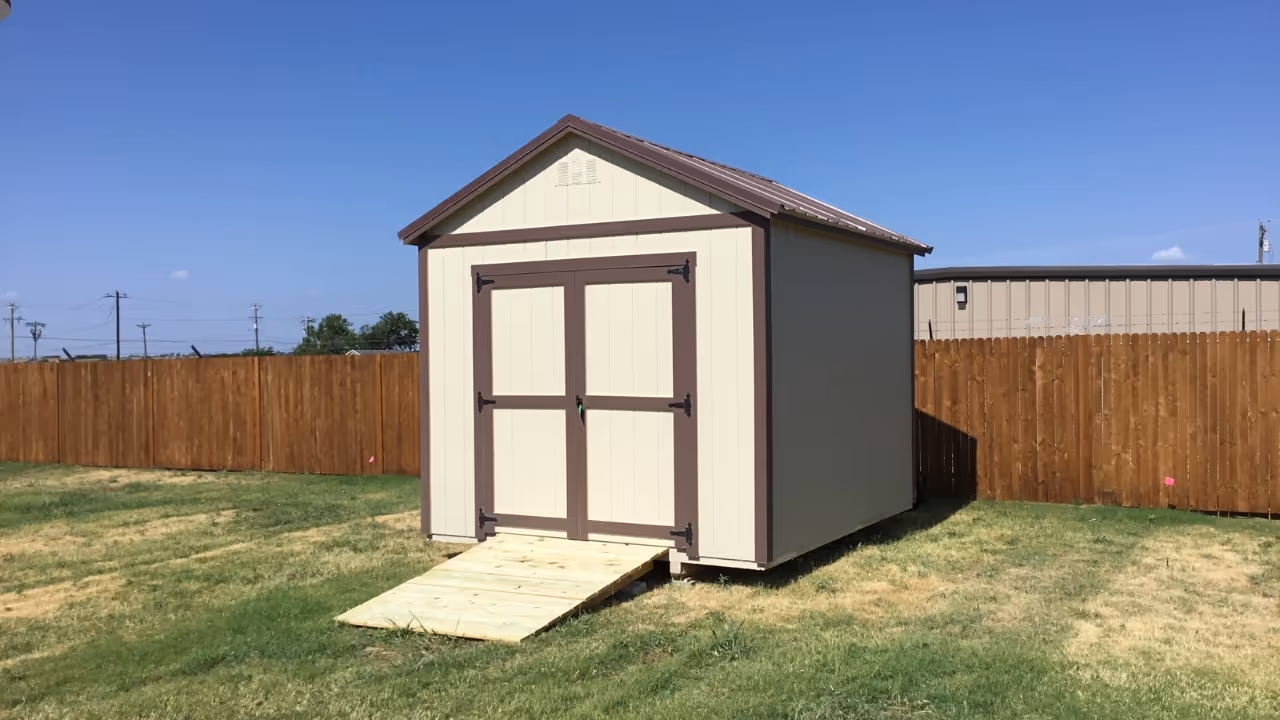 Person moving a shed using a shed mule
