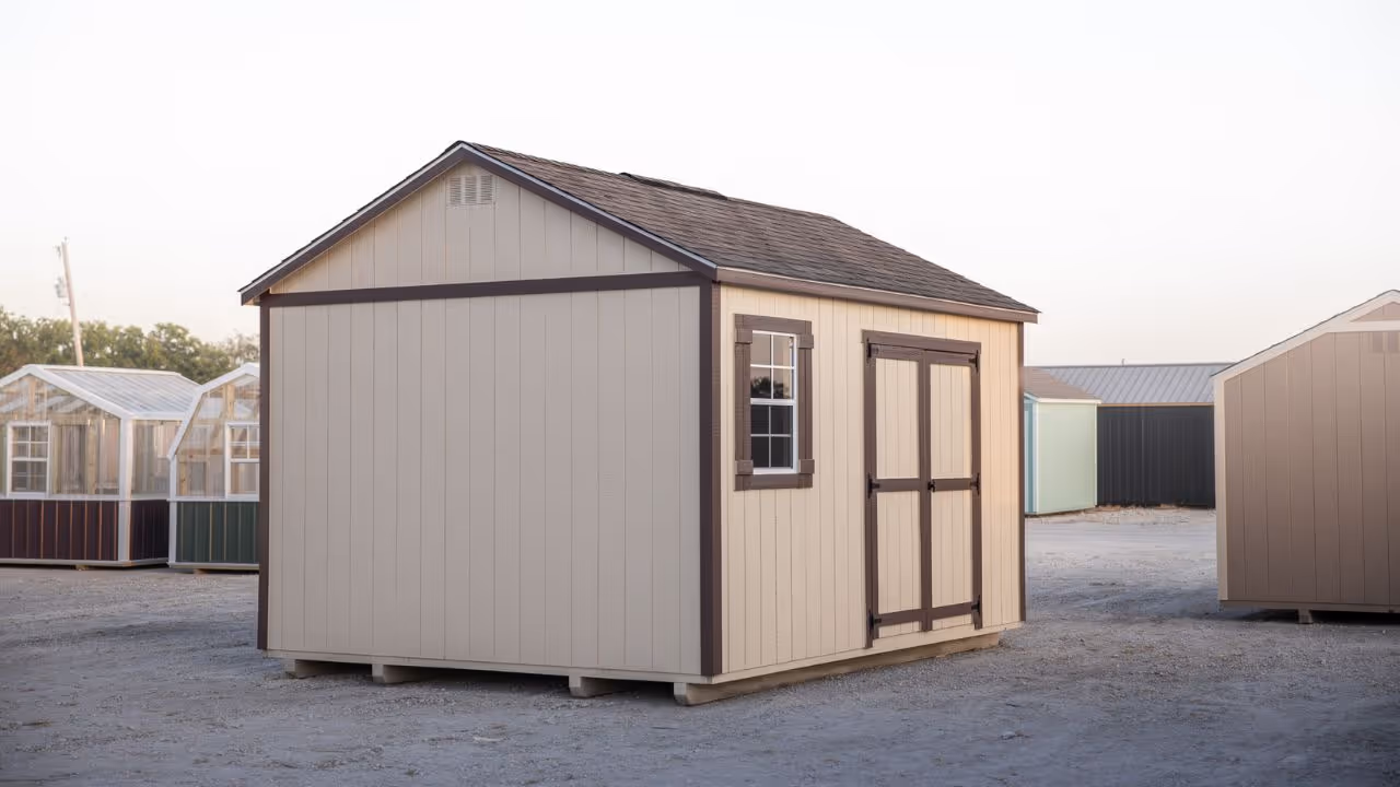 Person moving a shed using a shed mule