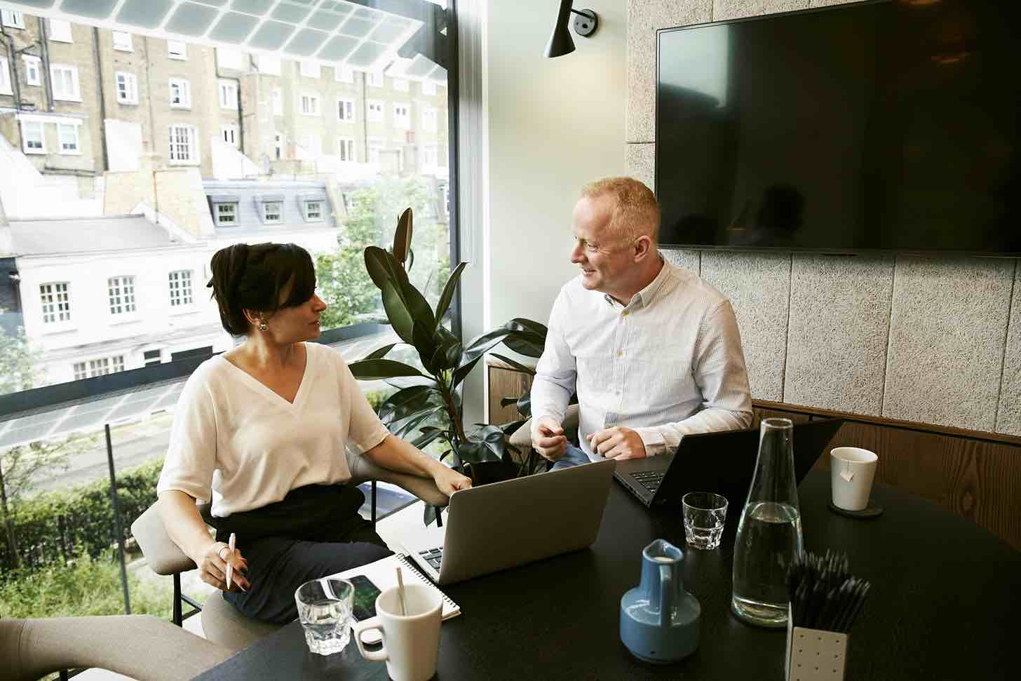 man and woman meeting in office