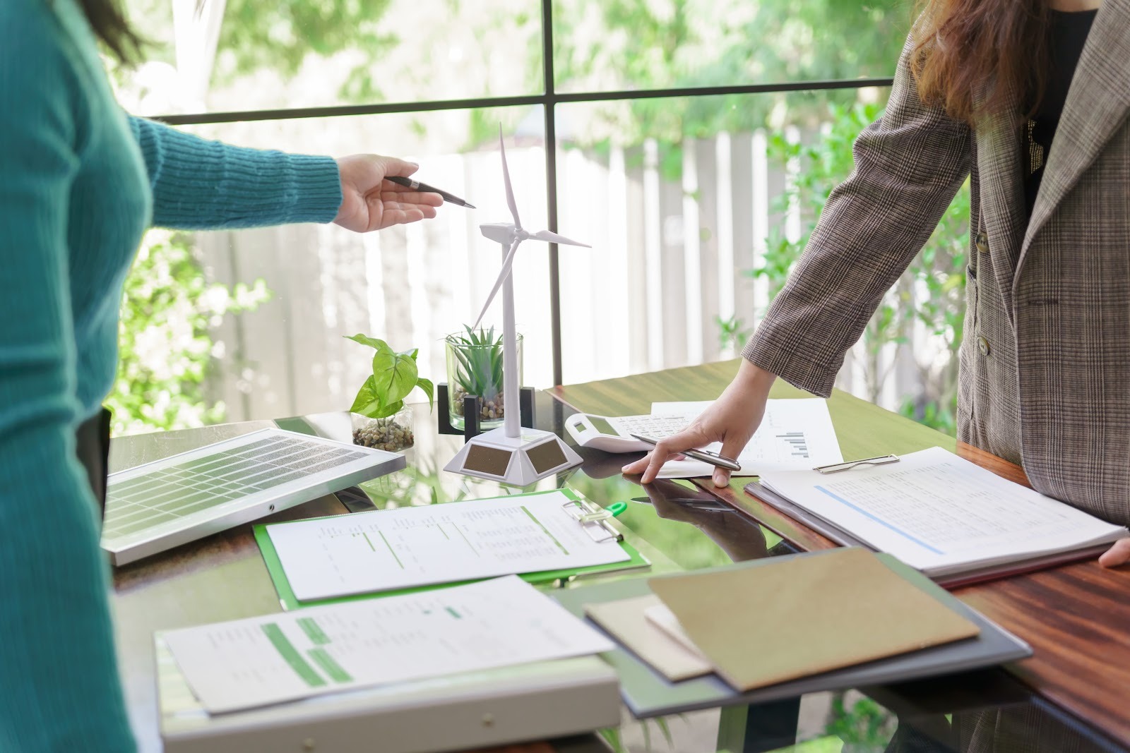 Female sustainability professionals talking about renewable energy