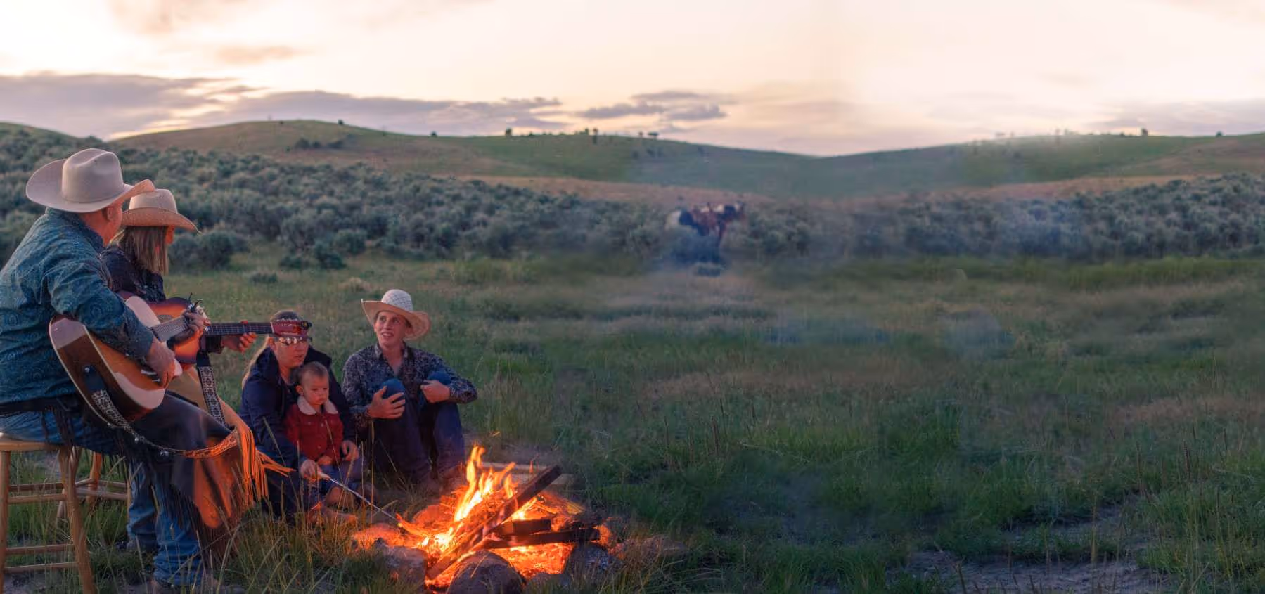 Photo of people by a campfire
