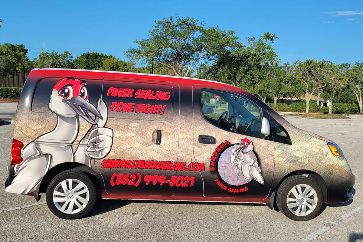 a van parked in a parking lot with advertising on it