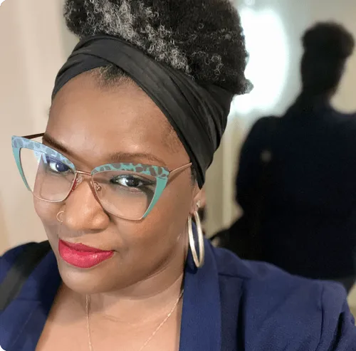a woman wearing glasses and a head scarf